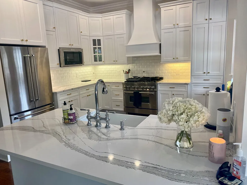 The same South Tampa kitchen after painting, with white cabinets, subway tile backsplash and quartz counters