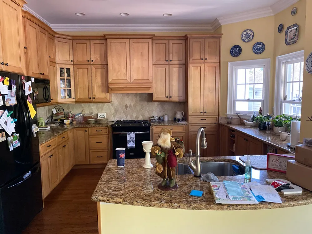 South Tampa kitchen before painting, with honey maple raised-panel cabinets, tumbled stone backsplash and granite counters